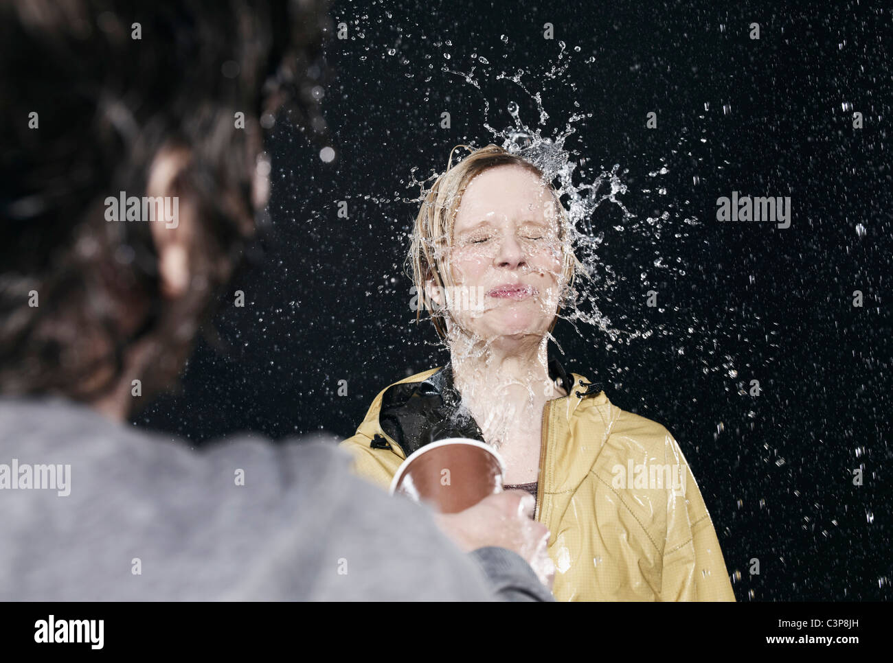 Men throwing water on women Stock Photo Alamy