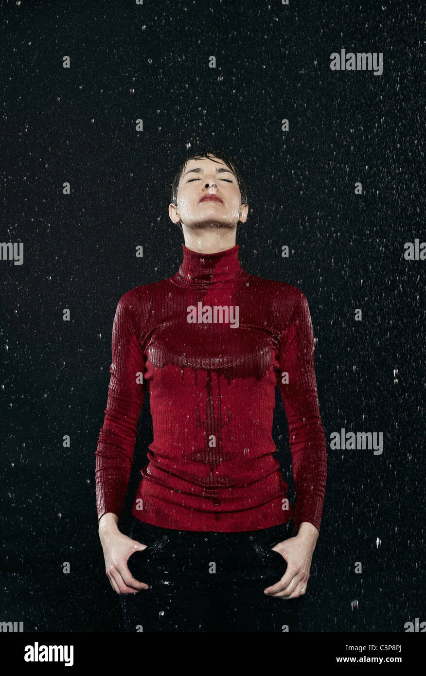 Woman getting wet in rain Stock Photo Alamy