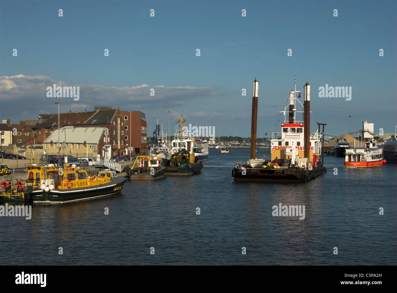 Poole Quay, Dorset, with a dredger and other boats in the picture UK Stock Photo