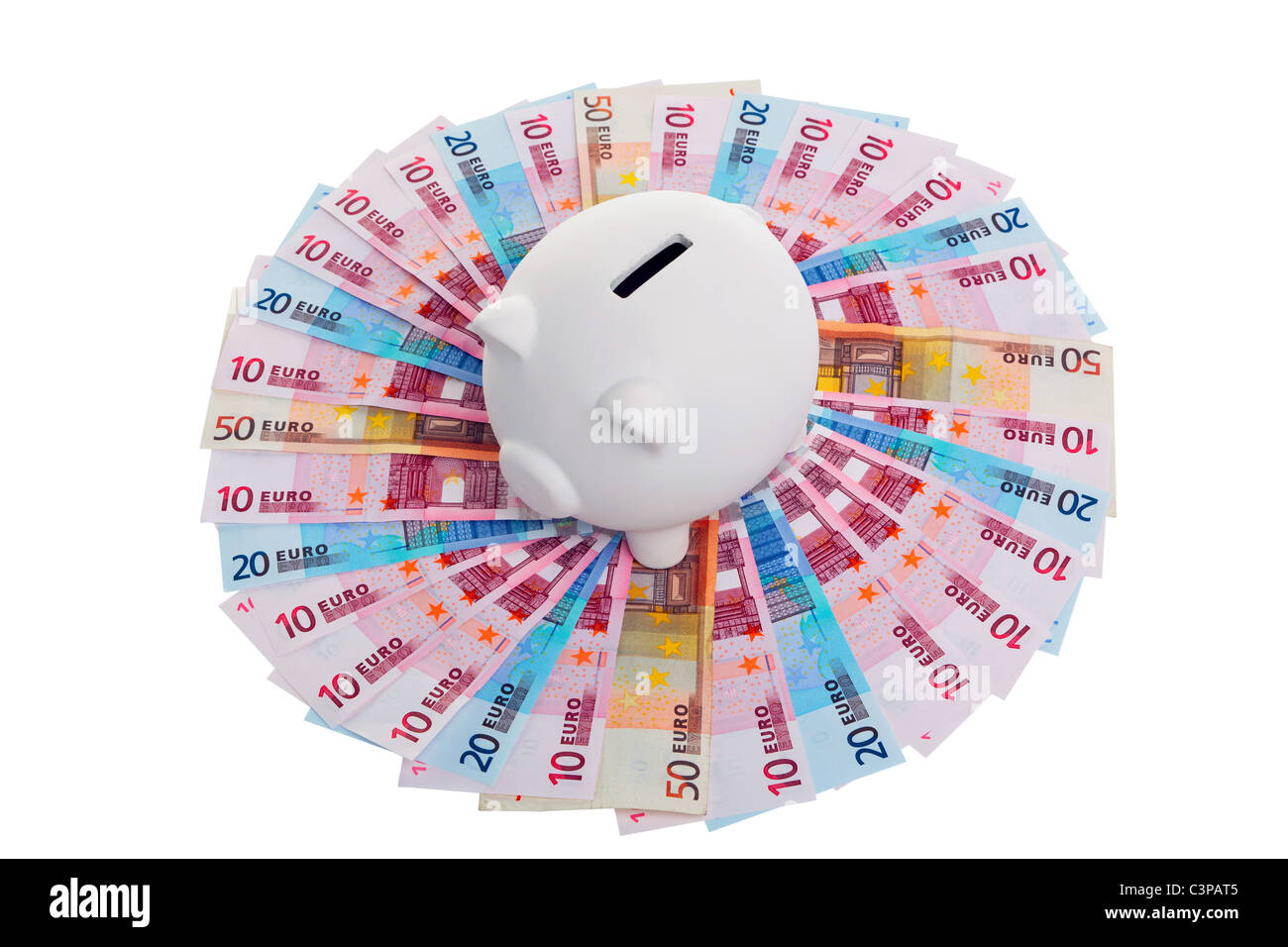 Photo of a piggy bank on a circle of Euro banknotes, cut out on a white background Stock Photo
