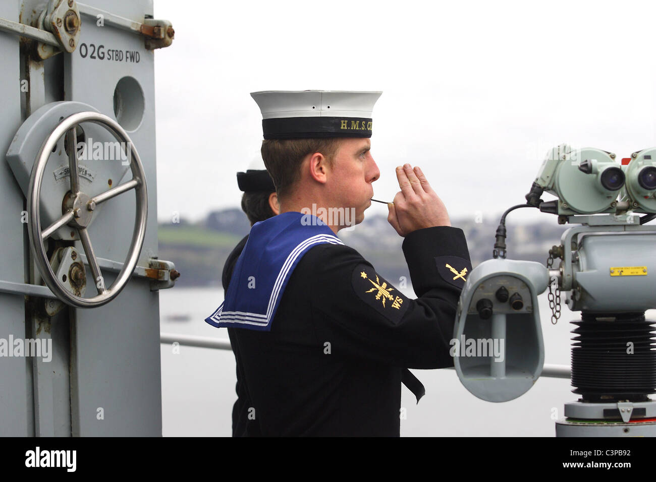 Royal Navy sailor pipes a salute Stock Photo Alamy