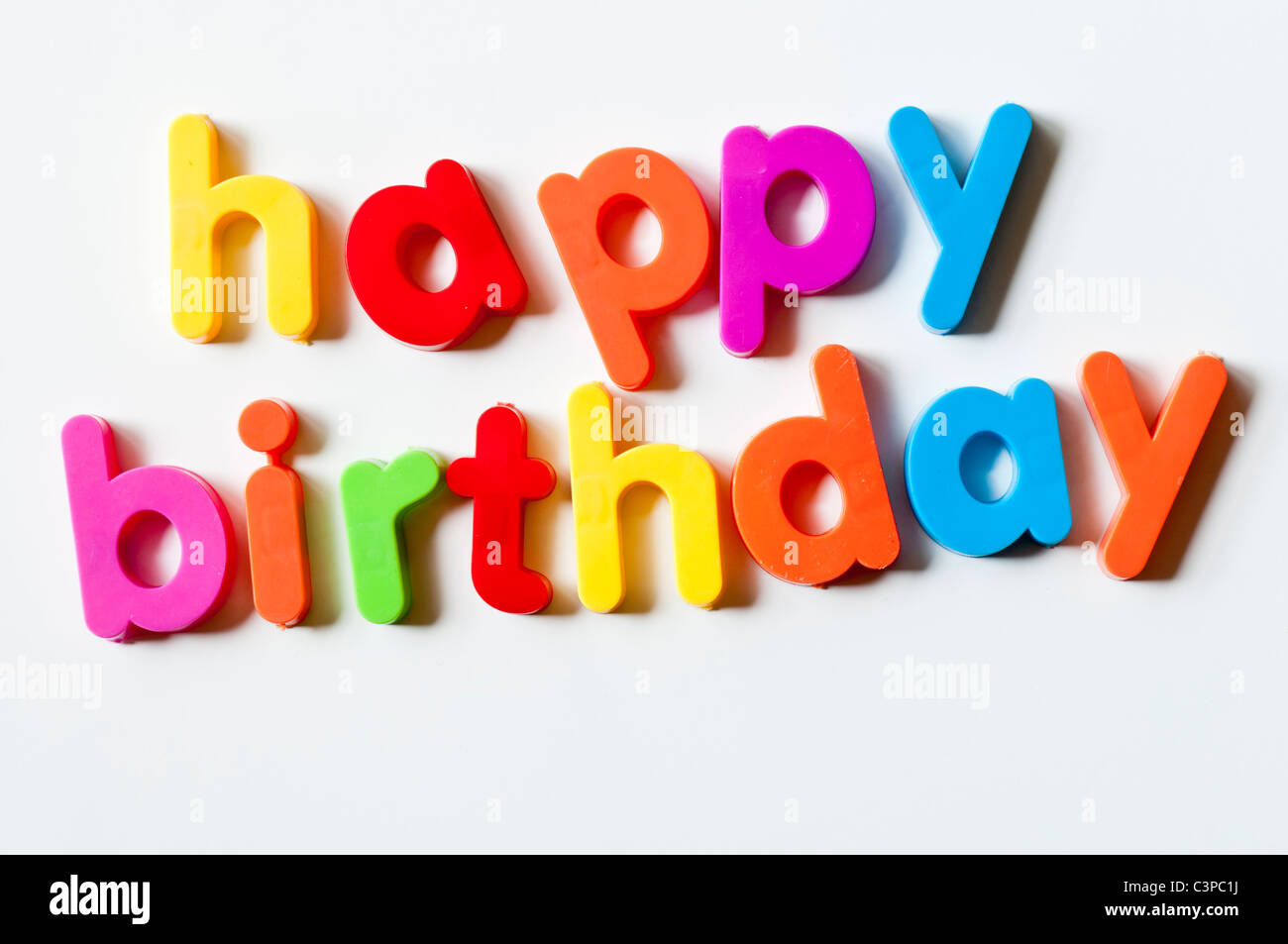 Fridge magnets magnetic letters spelling out 'happy birthday' Stock Photo