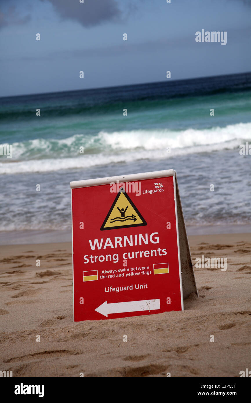 Sign on Porthmeor Beach, St Ives, Cornwall, warning of strong currents in the sea Stock Photo