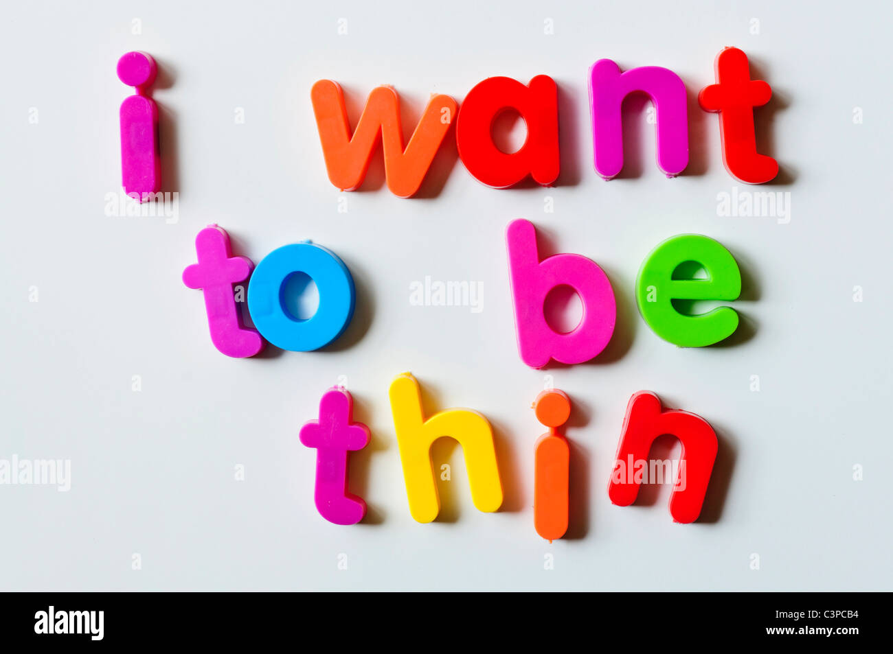 Fridge magnets magnetic letters spelling out 'I want to be thin' Stock Photo