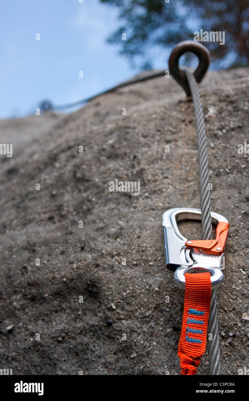Climbing carabiner on a steel rope via ferrata Stock Photo Alamy