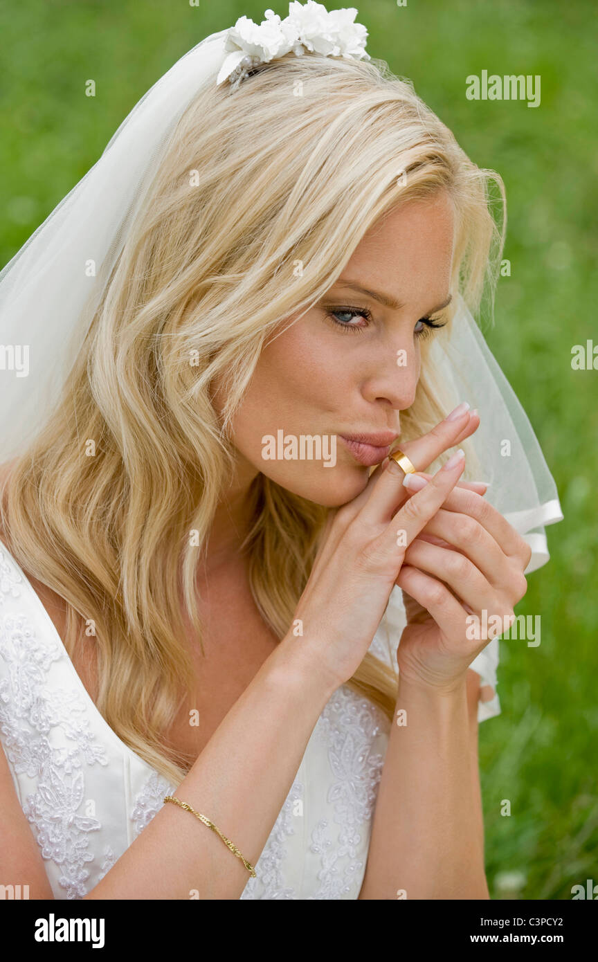 Bride kissing her wedding ring Stock Photo Alamy