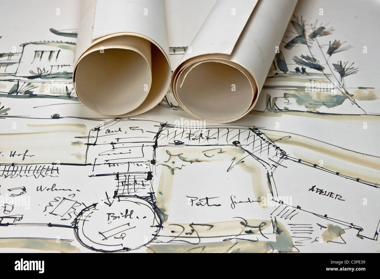 the blueprint of a house with two paper rolls Stock Photo