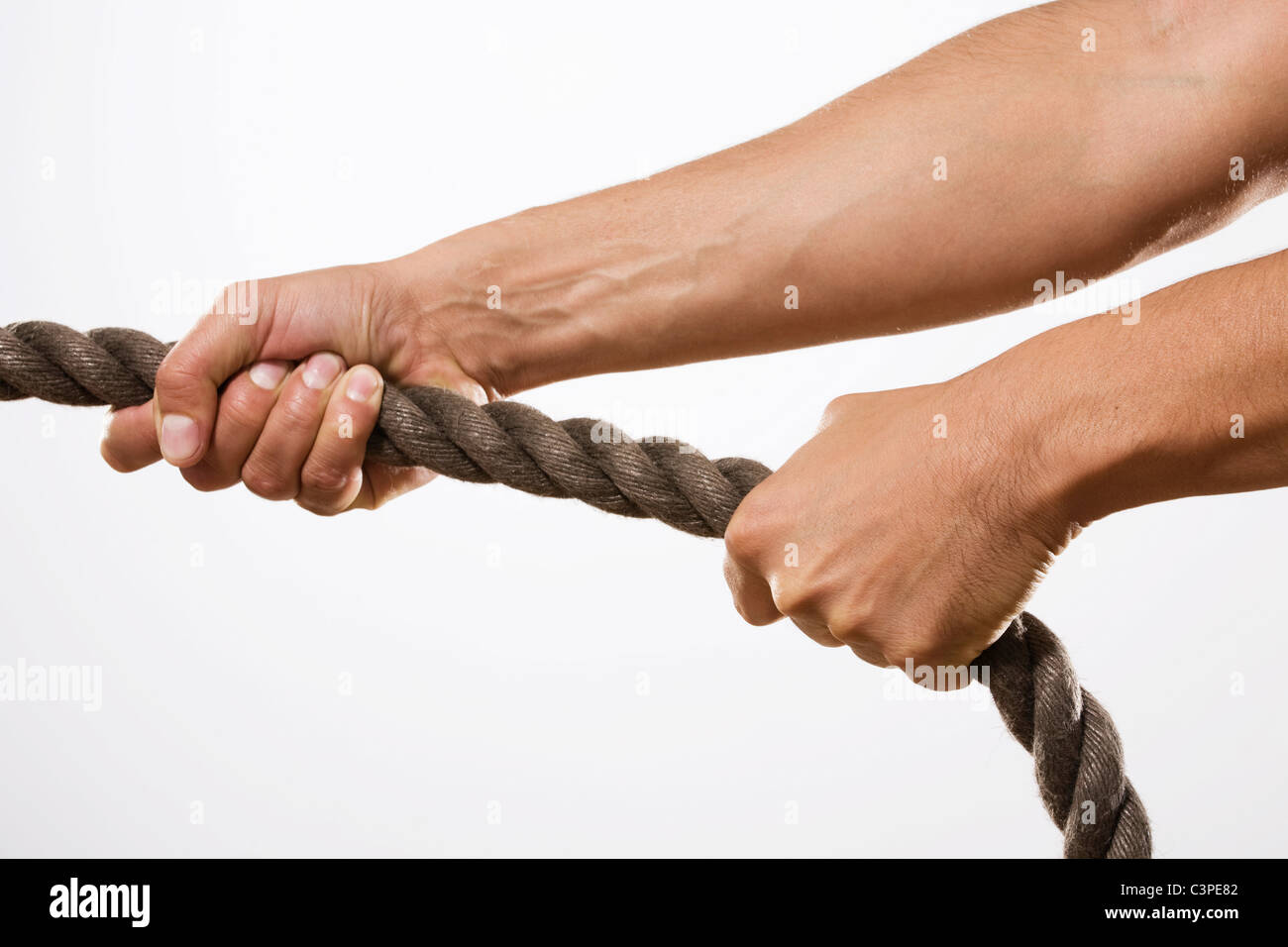 Person pulling rope, close-up Stock Photo