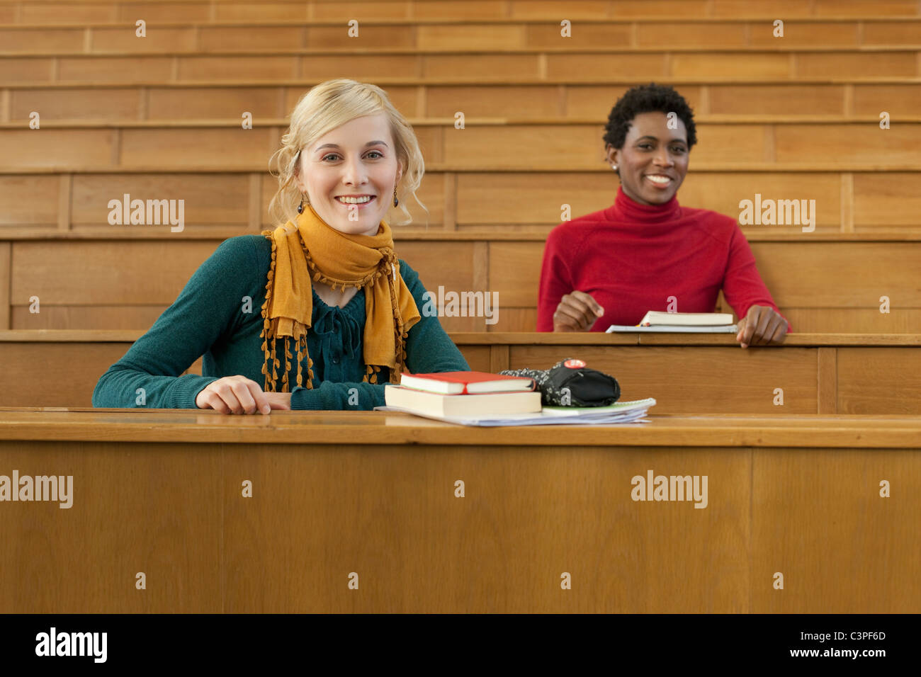 Germany, Leipzig, Students sitting in auditorium, smiling, portrait Stock Photo