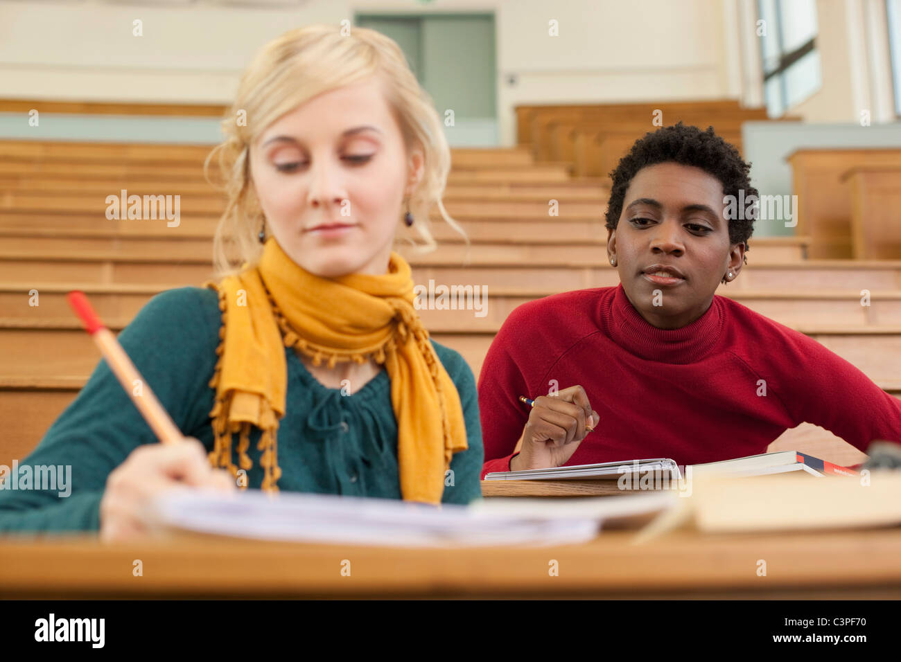 Germany, Leipzig, Students sitting and studying in auditorium Stock Photo