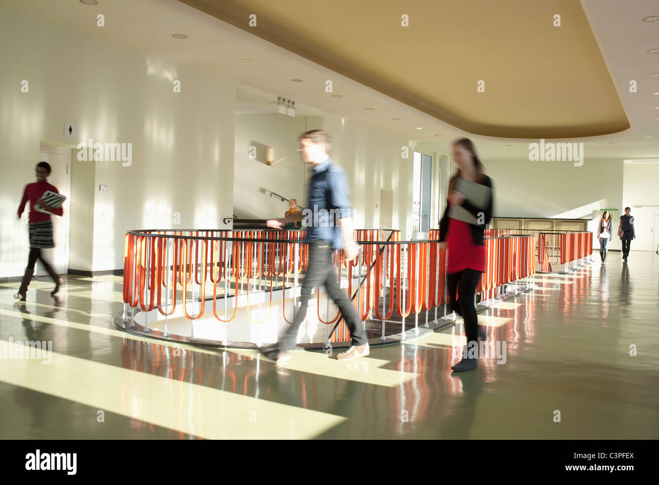 Germany, Leipzig, University students walking through corridor (blurred motion) Stock Photo