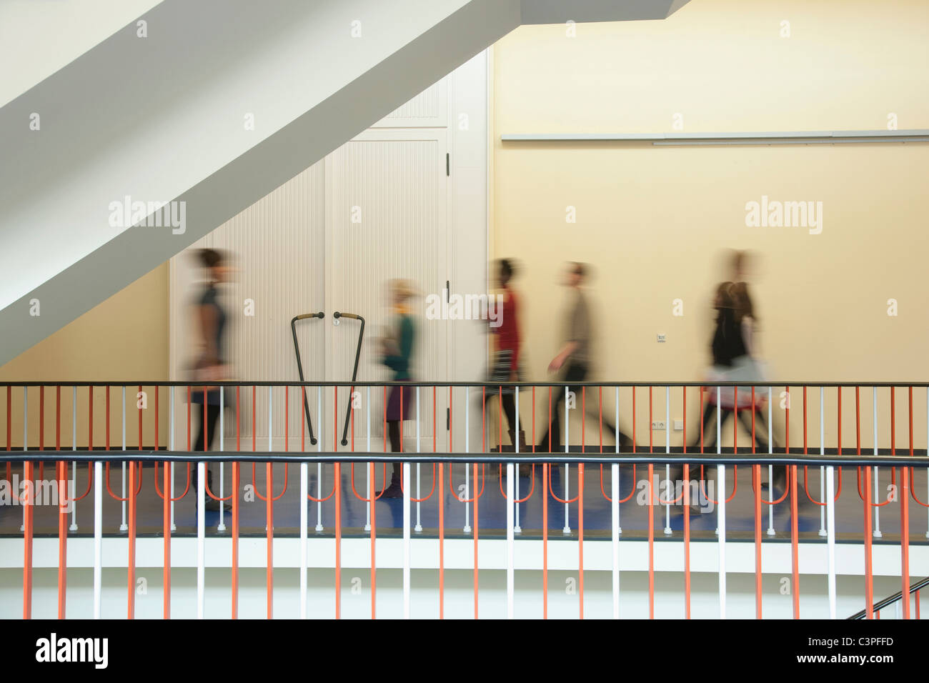Germany, Leipzig, Group of university students walking through corridor (blurred motion) Stock Photo