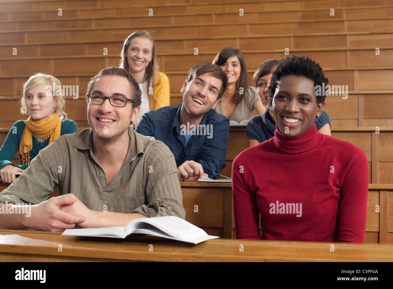 Germany, Leipzig, Group of university students studying in classroom
