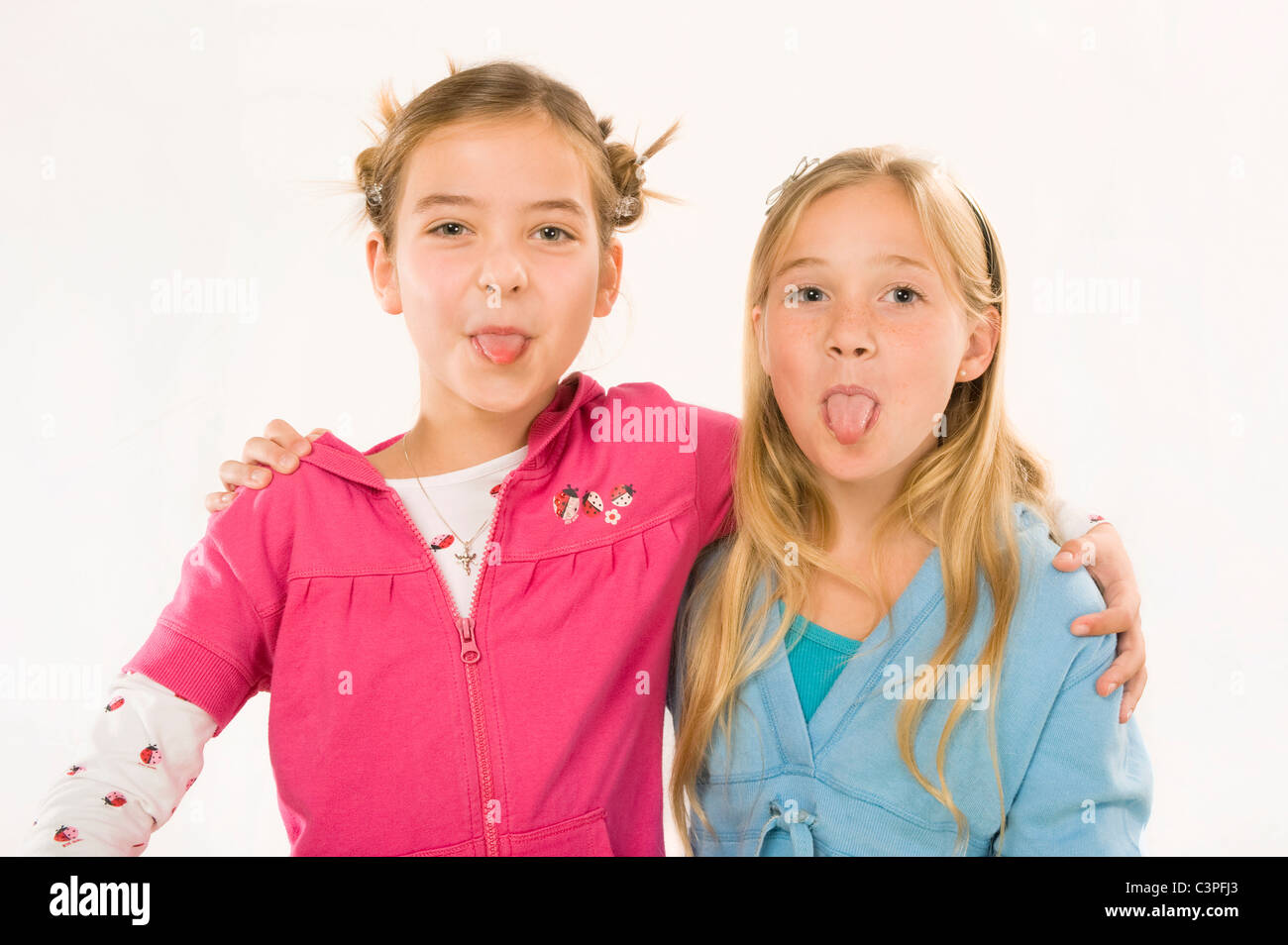 Two Girls 8 9 Embracing Sticking Out Tongues Smiling Portrait