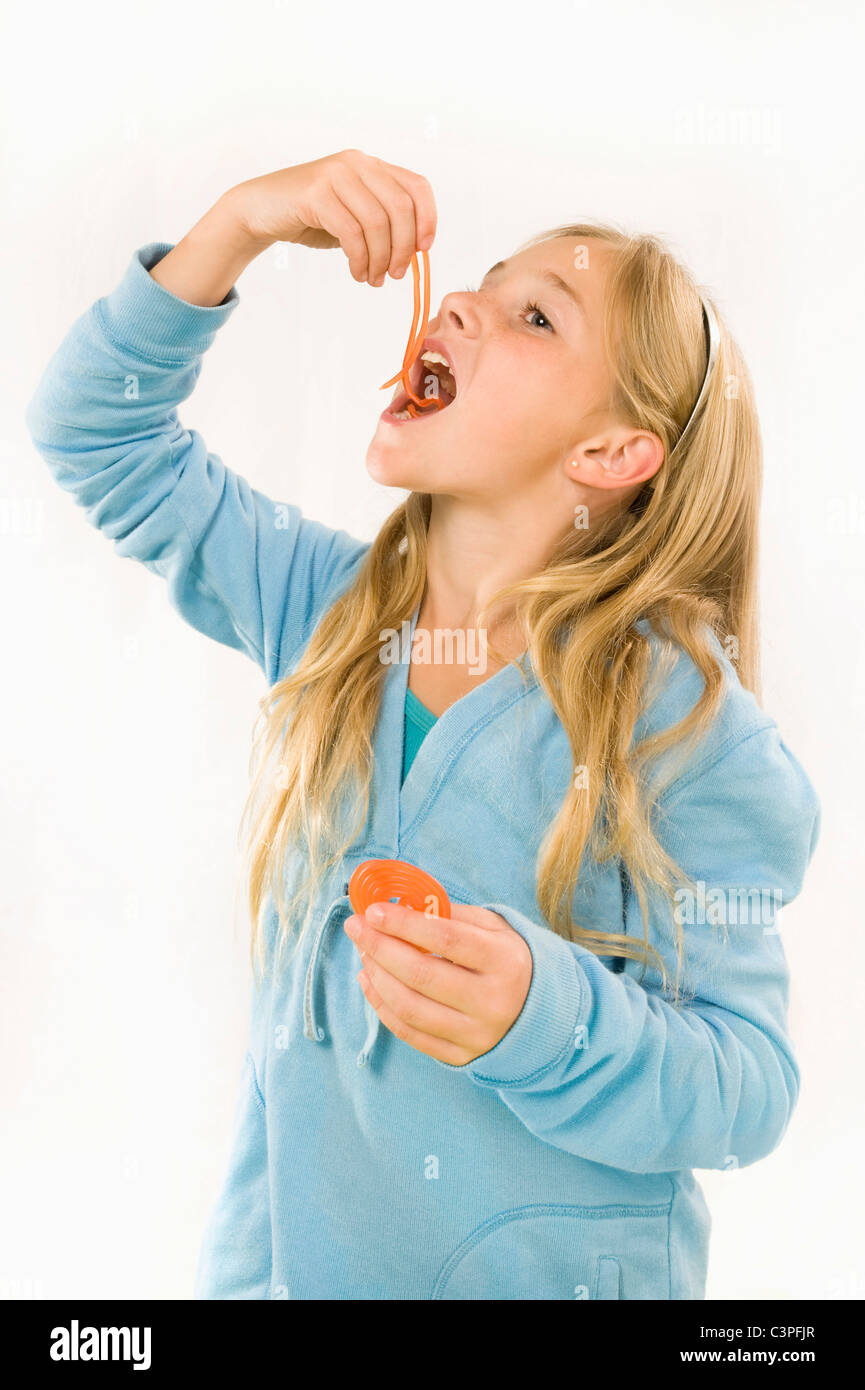 Girl (89) eating wine gum, smiling, portrait Stock Photo Alamy