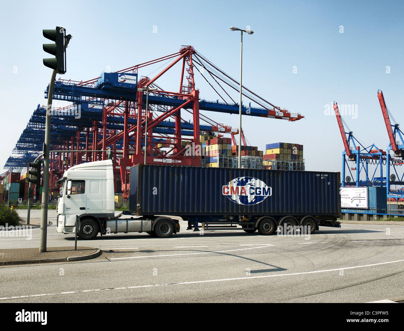 Truck with CMA CGM 40' container leaving the container terminal Burchardkai passing the Eurogate in the Port of Hamburg, Germany Stock Photo