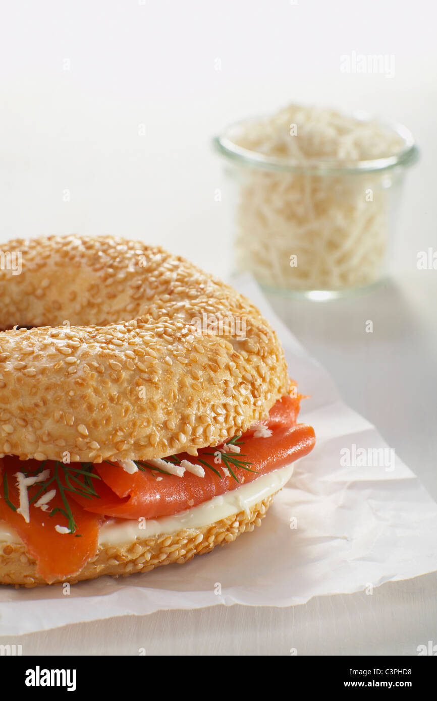 Smoked salmon bagel, horseradish, dill, mayonnaise on white background