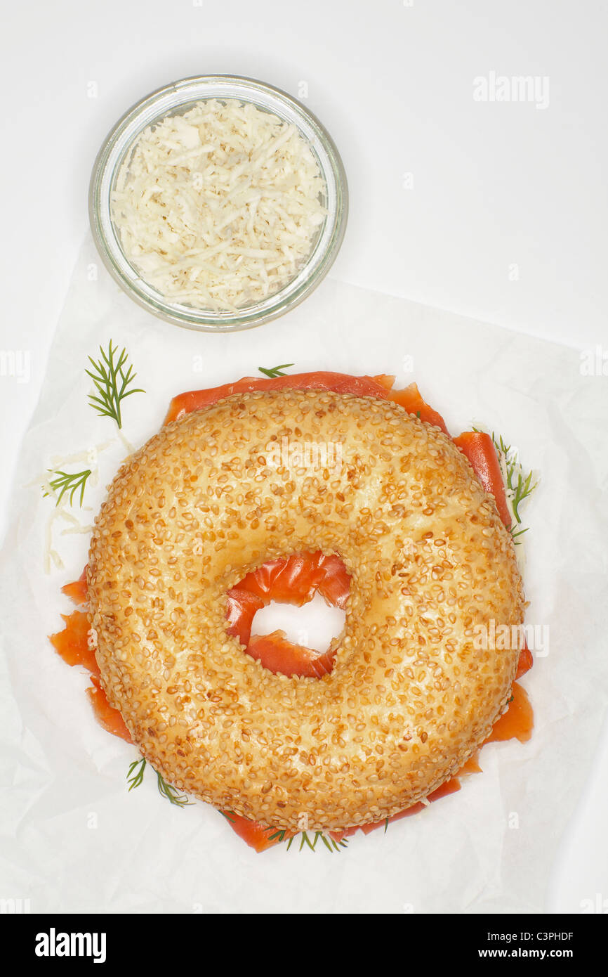 Smoked salmon bagel, horseradish, dill, mayonnaise on white background