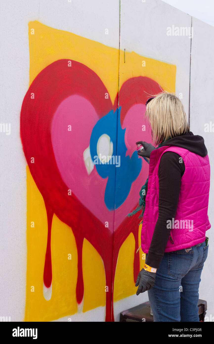 Cleo Heard  Female Graffiti Artist at work at the Southport Jam Legal Wall  UpNorthFest  Merseyside, UK Stock Photo