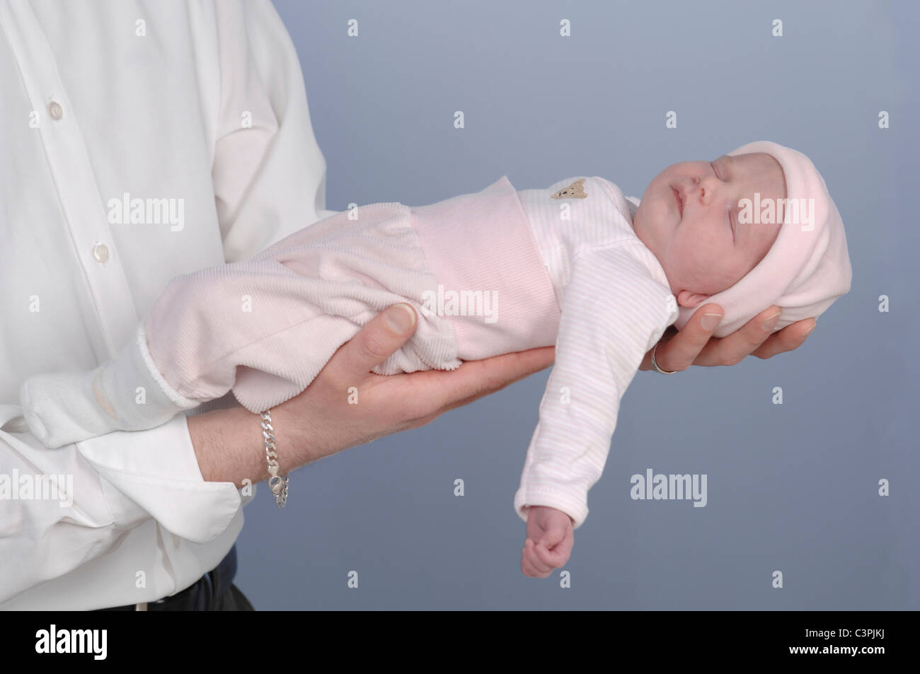 Man holding sleeping baby girl (0-1 months) Stock Photo