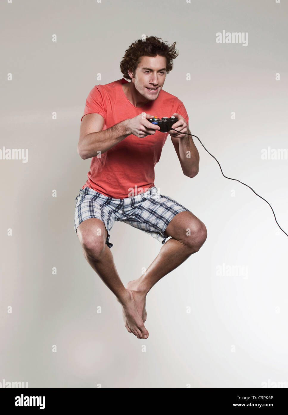 Man playing vedio game and jumping Stock Photo - Alamy