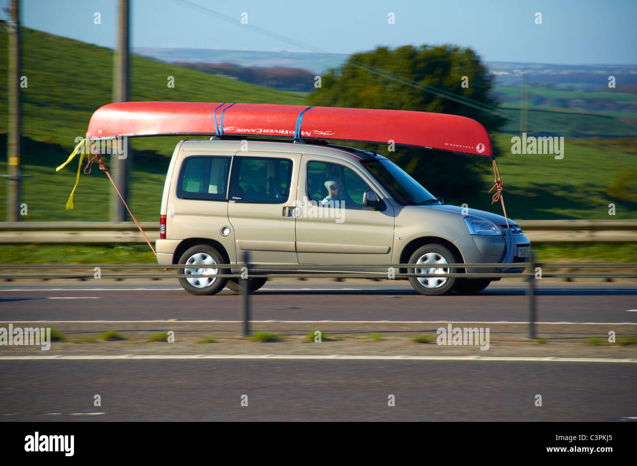 Boat on the roof of a car (on the M62). Stock Photo