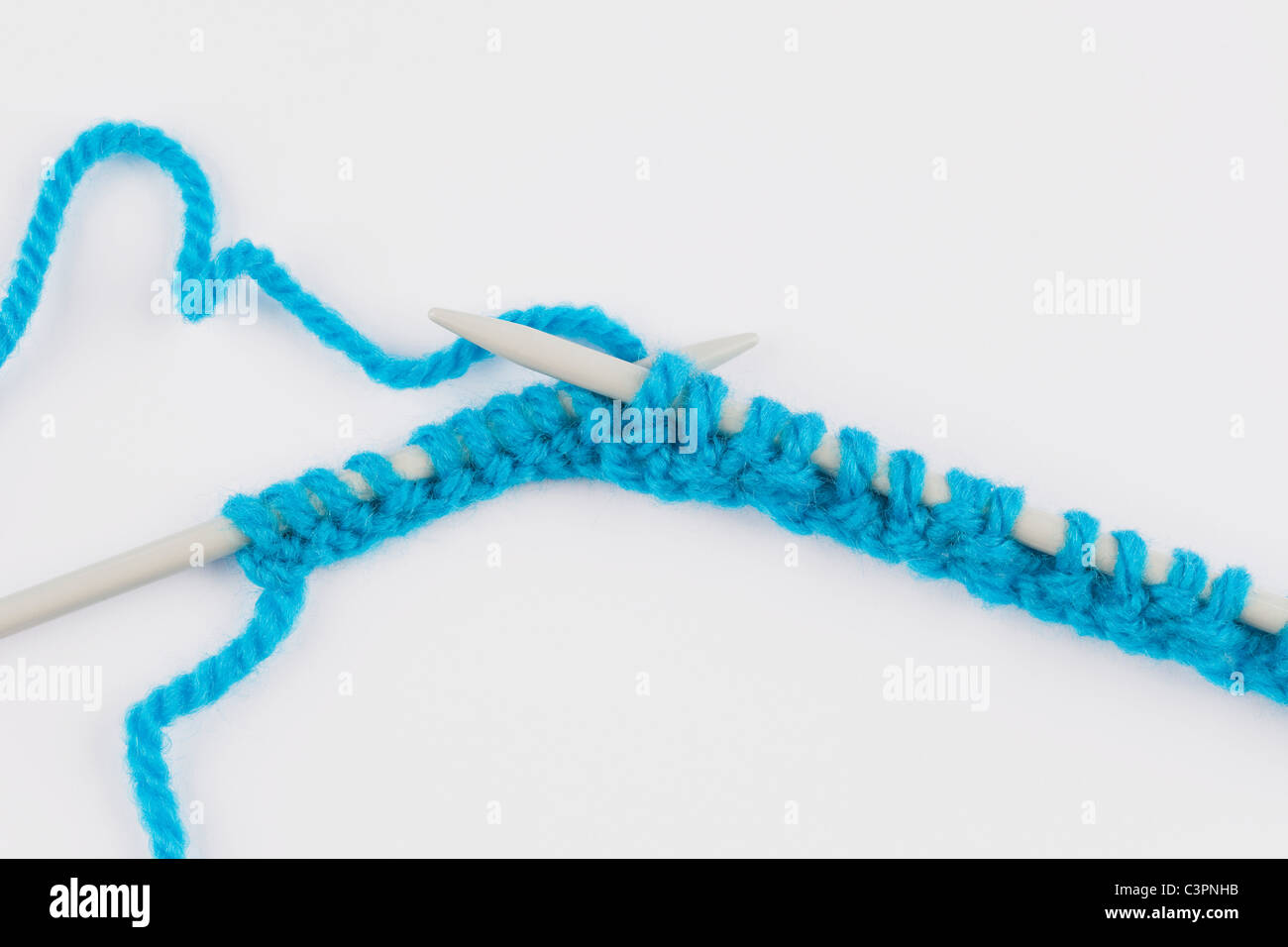 Blue knitting wool and knitting needles on white background Stock Photo ...