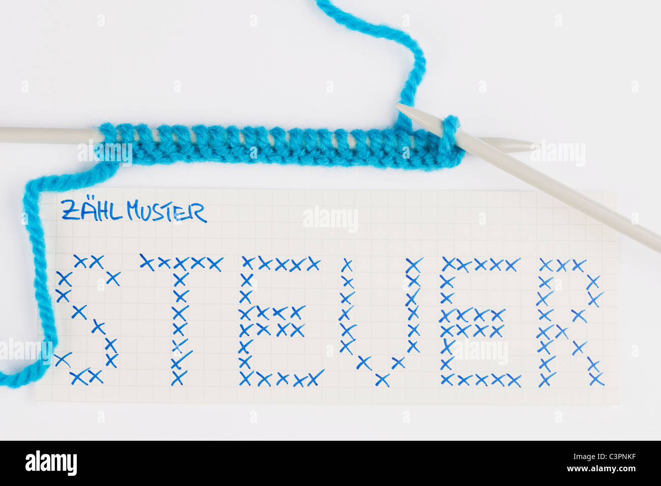 Knitting needles and wool with text steuer, Close up Stock Photo