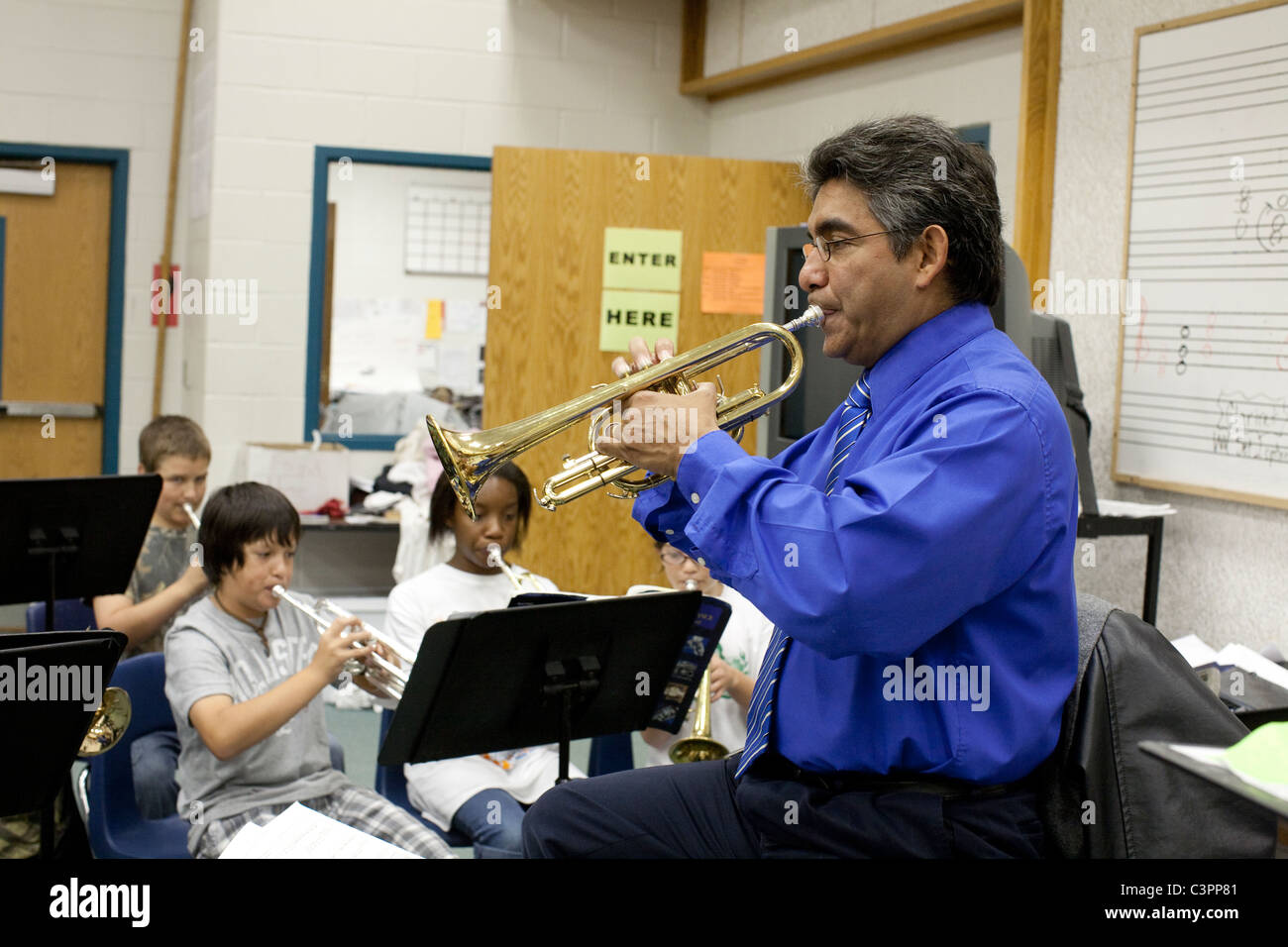 Male Pupil Playing Trumpet In High School Orchestra Stock Photo
