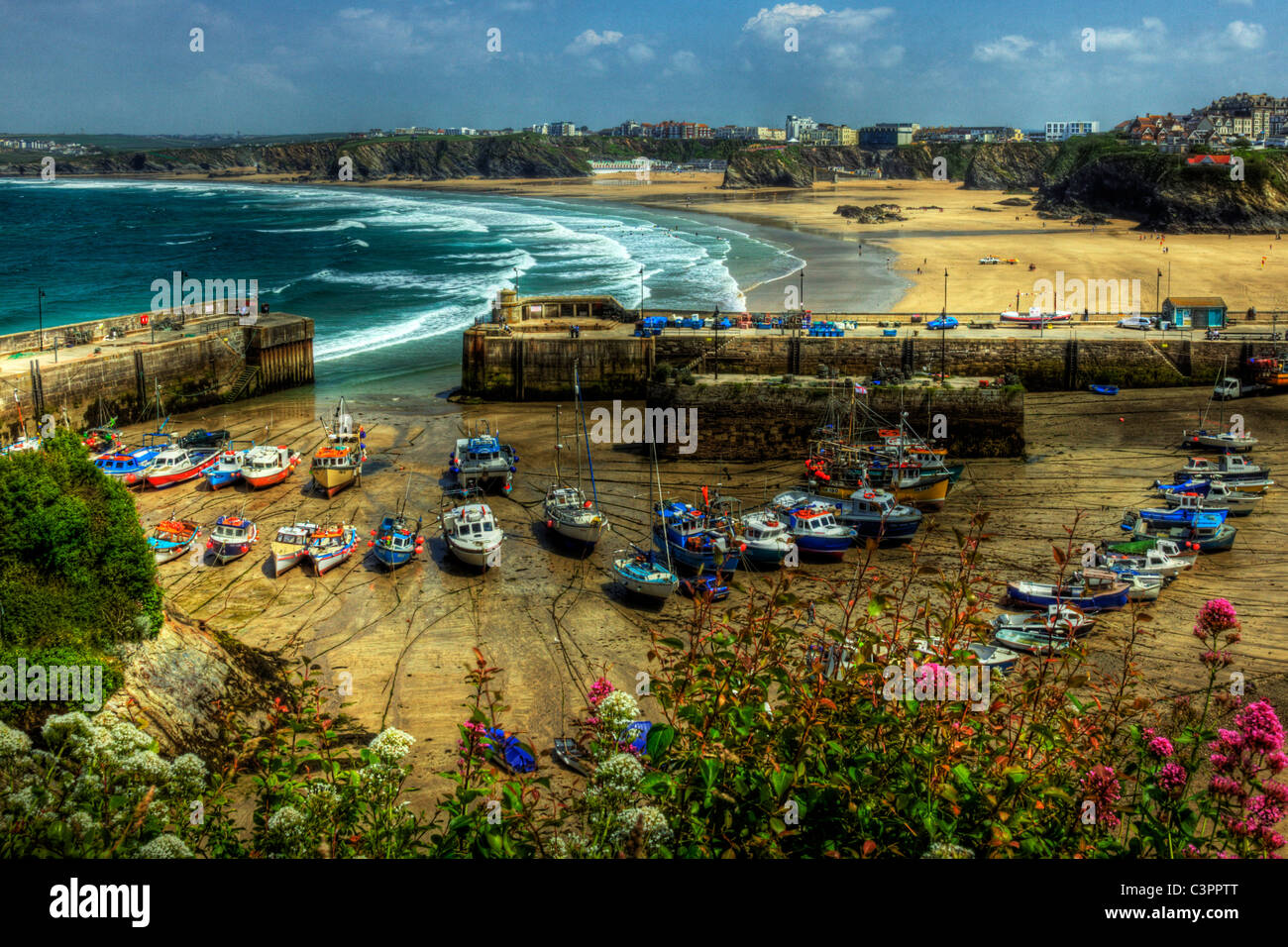 Small fishing boats in the harbour, harbor, at Newquay, Cornwall, England. Waiting for the tide Stock Photo