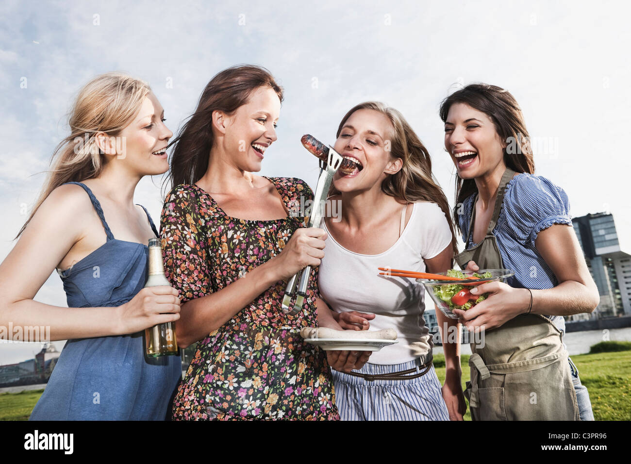 Germany, Cologne, Women enjoying beer and sausages Stock Photo - Alamy