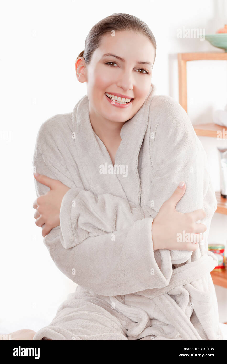 Woman in bathrobe with arms crossed, smiling, portrait Stock Photo Alamy