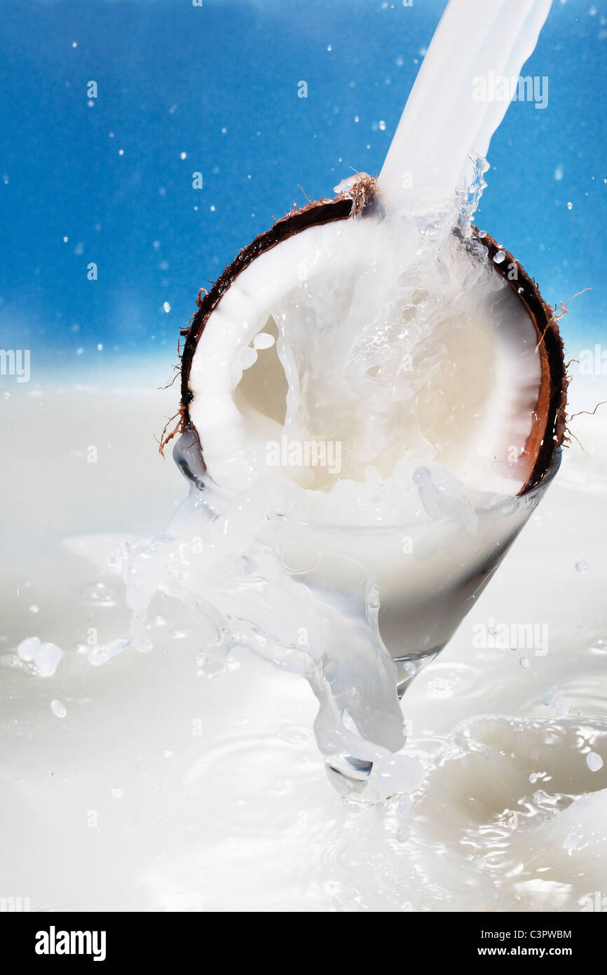 Coconut milk pouring on coconut, close up Stock Photo Alamy