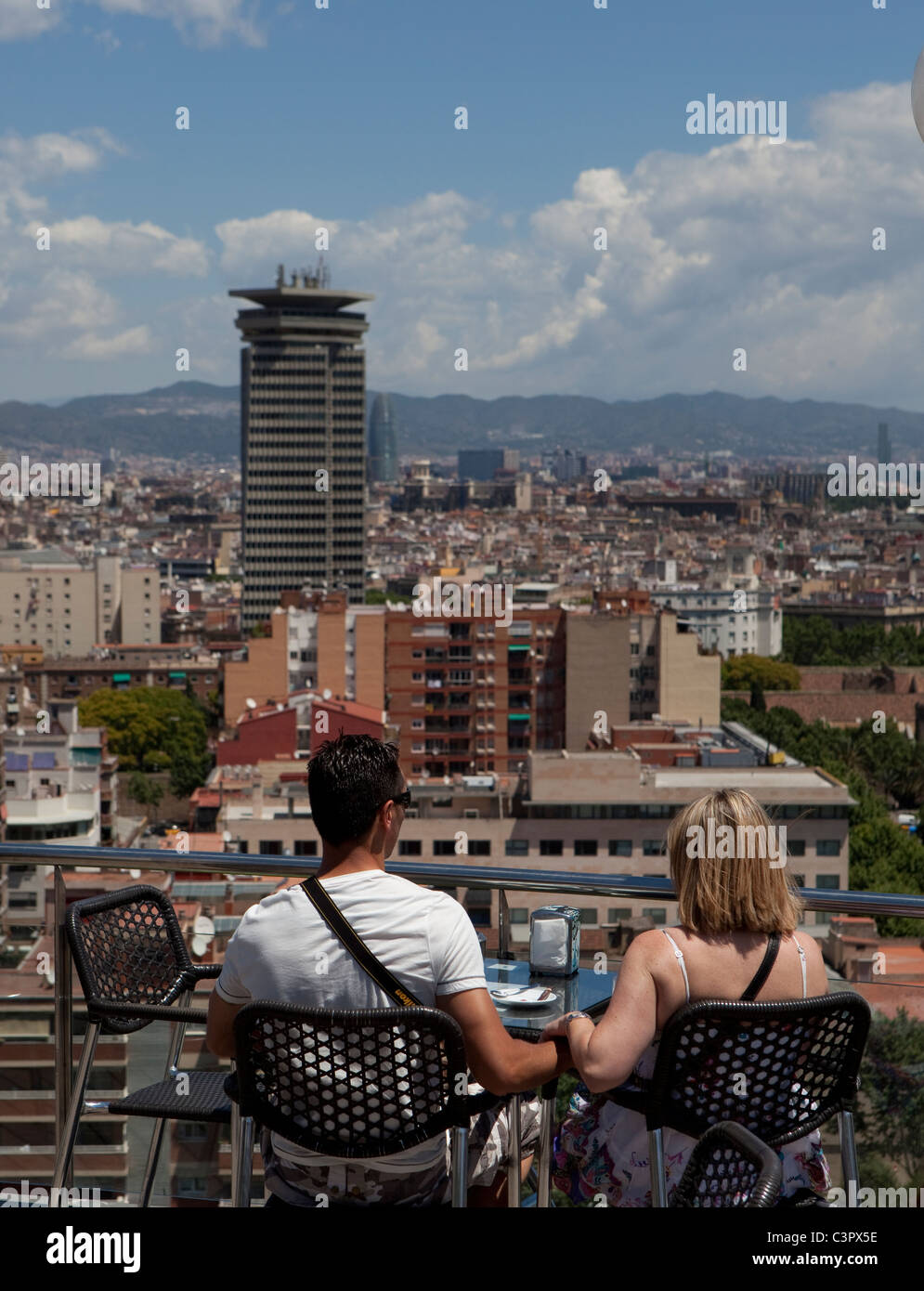 A couple holding hands while enjoy an areal view of Barcelona. Stock Photo