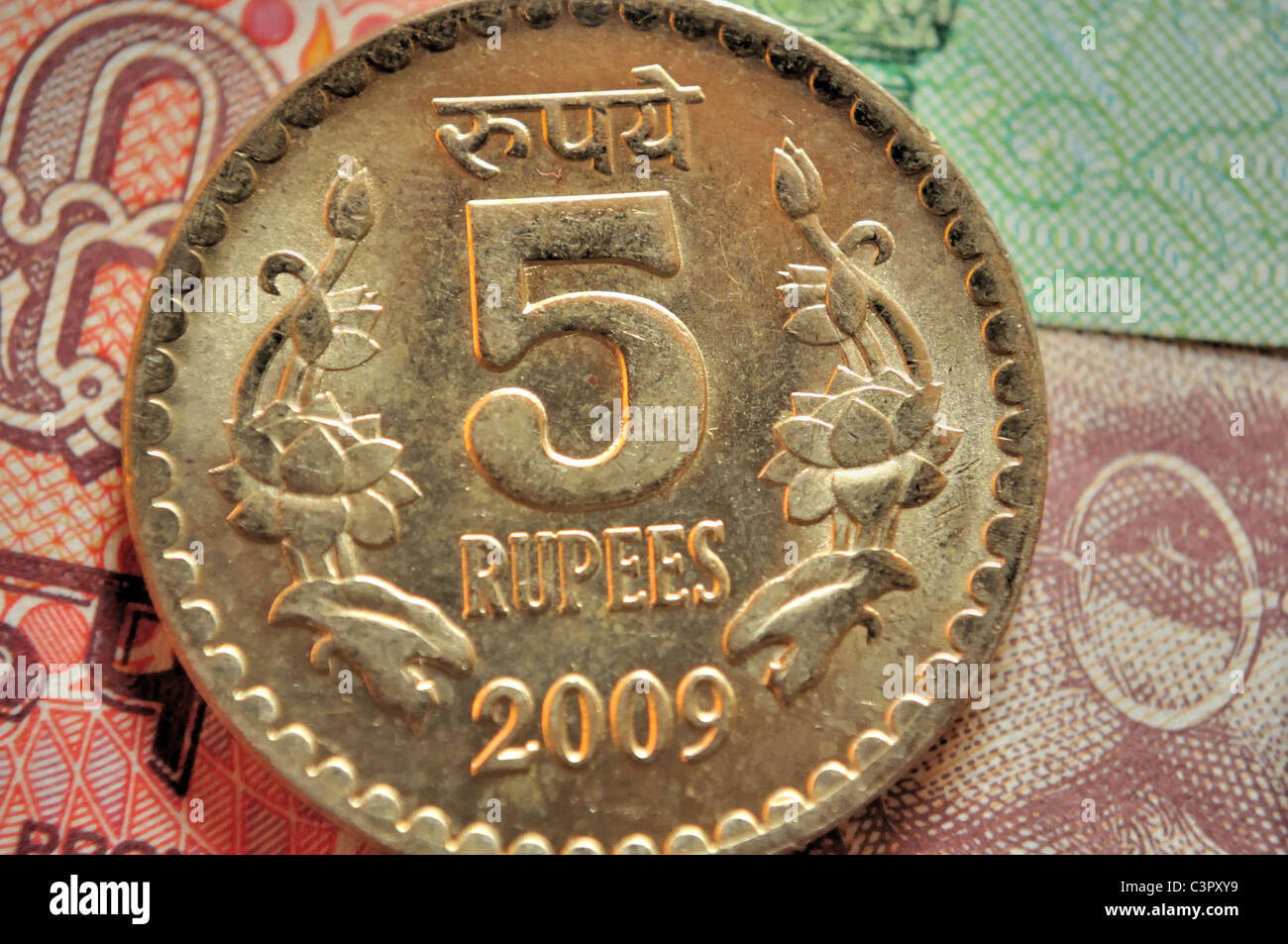 Close up of Indian currency coin of denomination Rs.5 of golden color