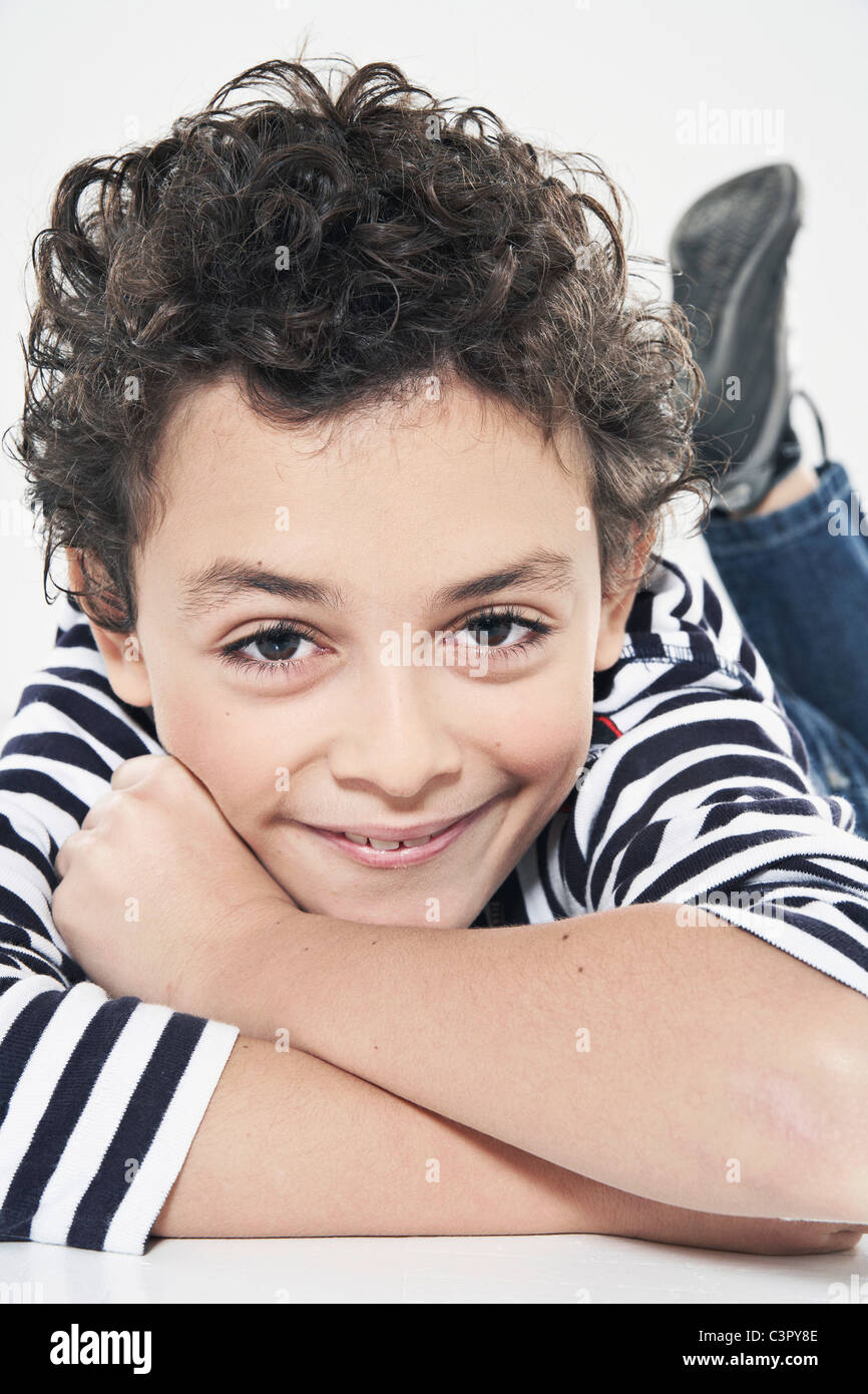 Boy (1011) lying with arms crossed, smiling, portrait Stock Photo Alamy