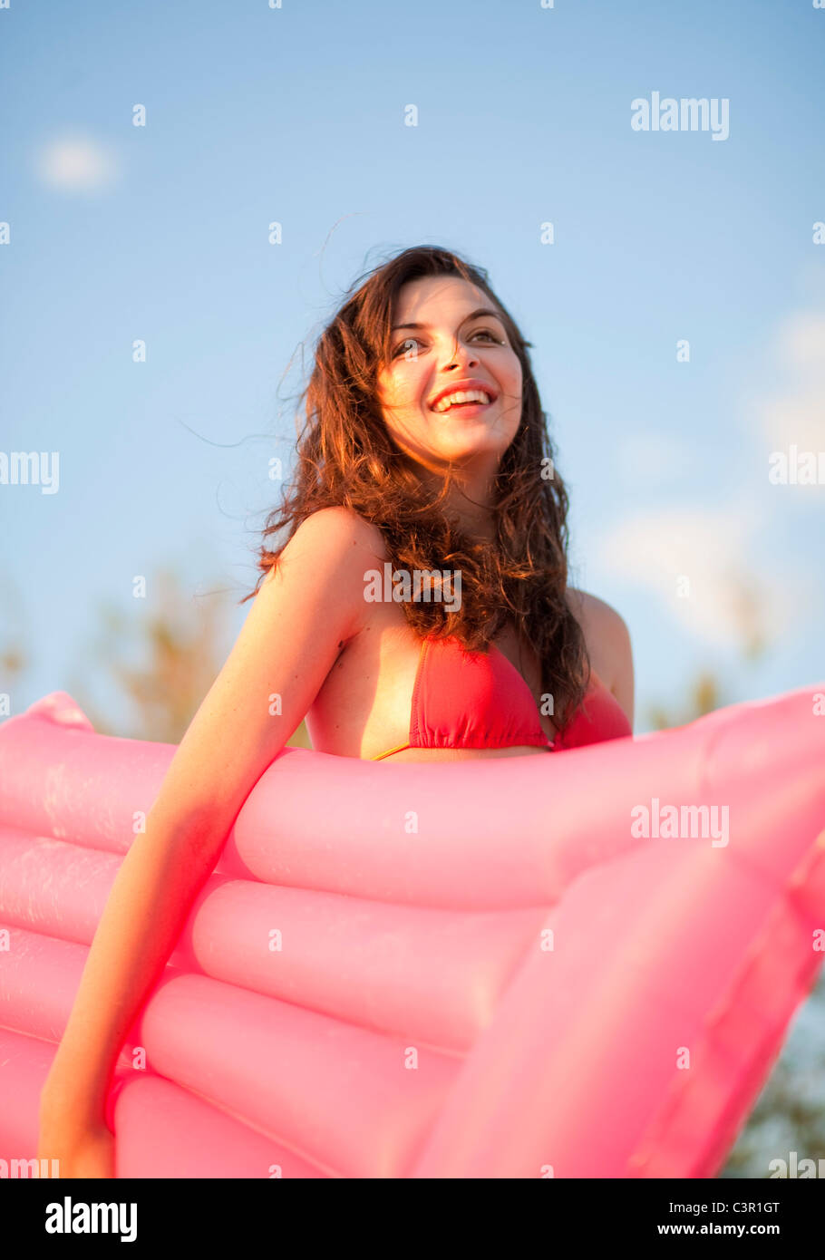 Croatia, Zadar, Young woman with air mattress on beach Stock Photo