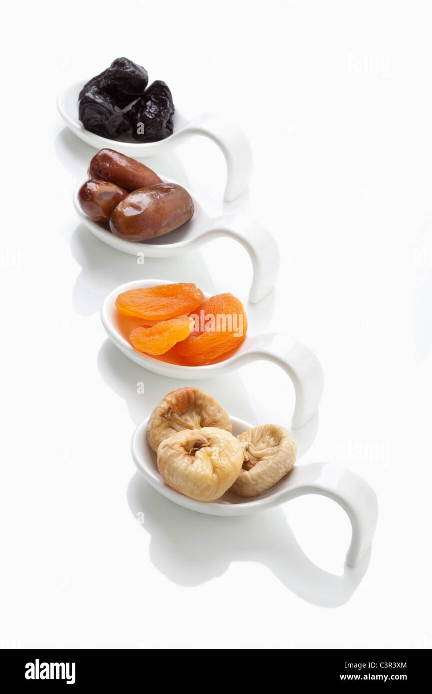 Variety of dried fruits in spoon on white background Stock Photo Alamy