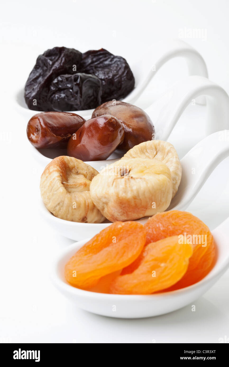 Variety of dried fruits in spoon on white background Stock Photo Alamy