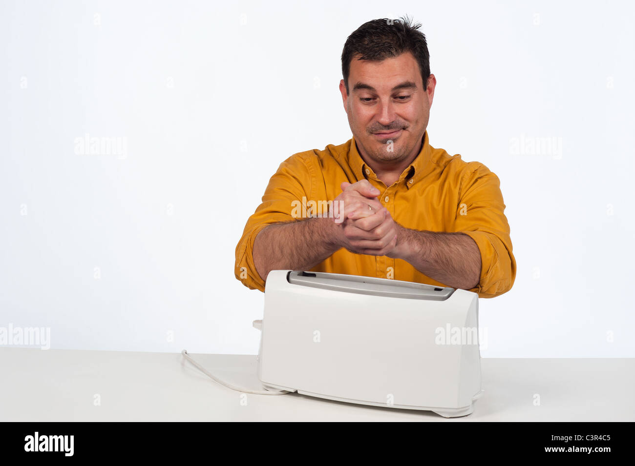 Stupid macho guy using a toaster as a heater Stock Photo Alamy