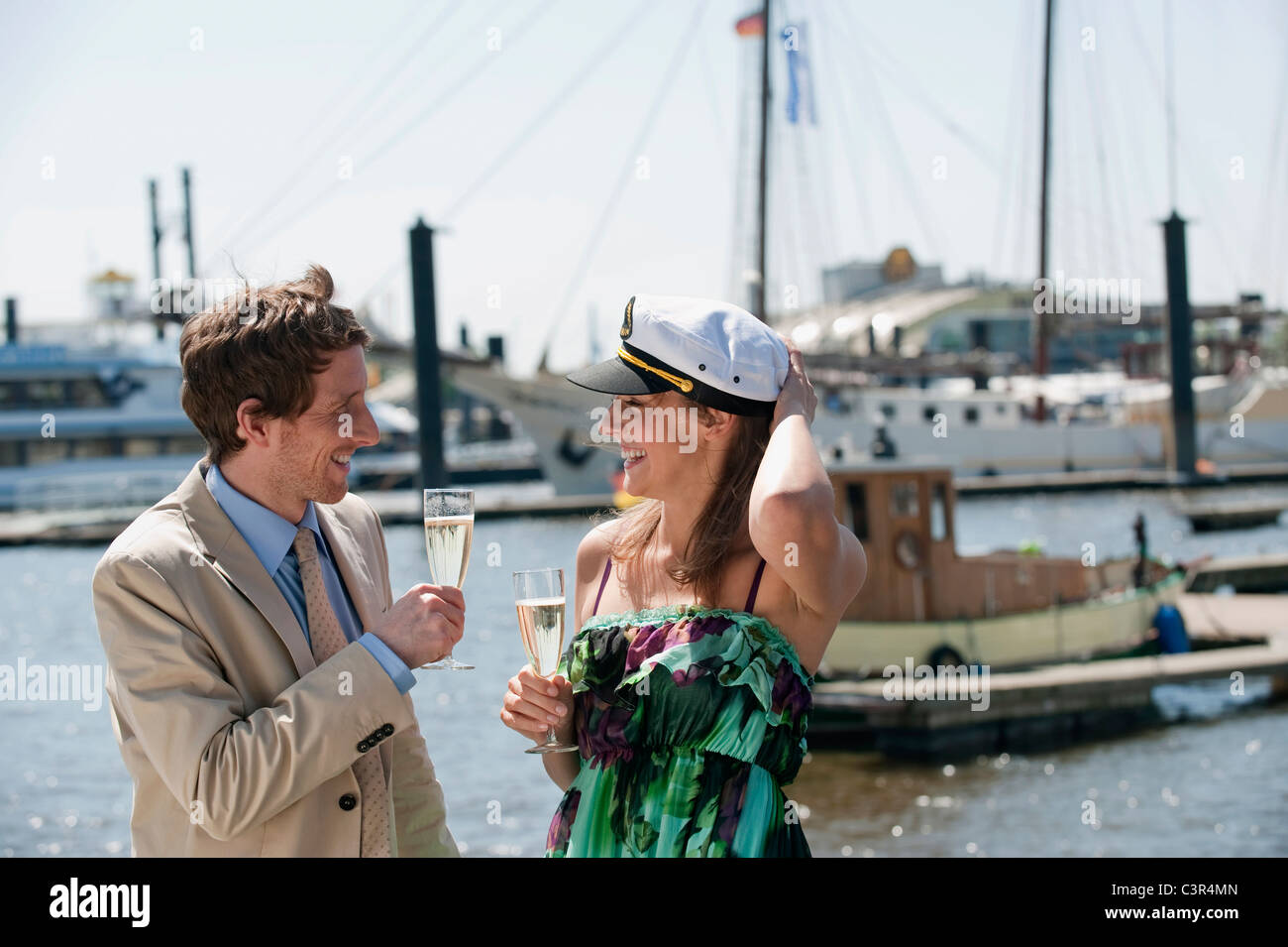 Germany, Hamburg, Couple drinking champagne, smiling Stock Photo