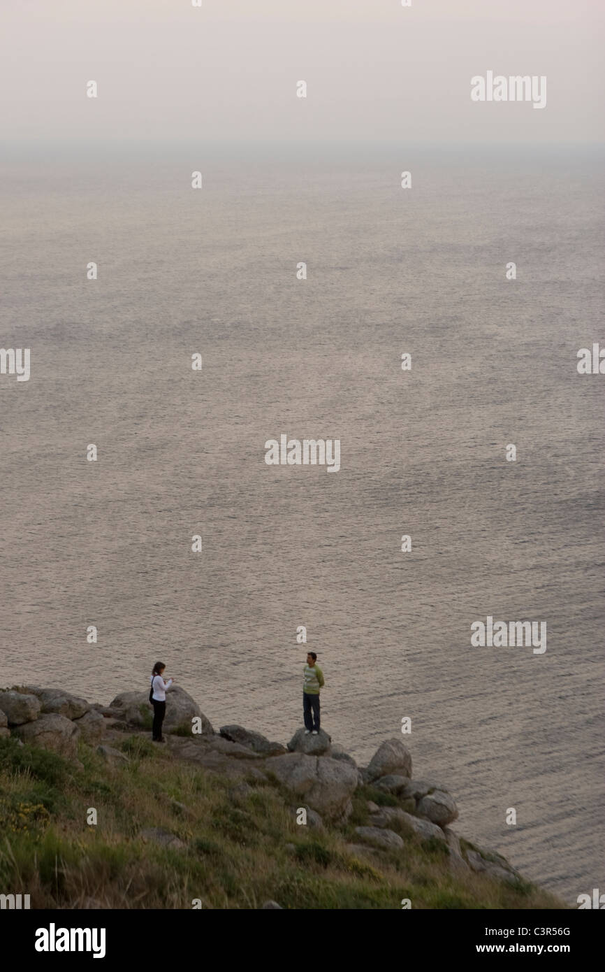 Couple at the edge Finisterre cape. Galicia, Spain Stock Photo