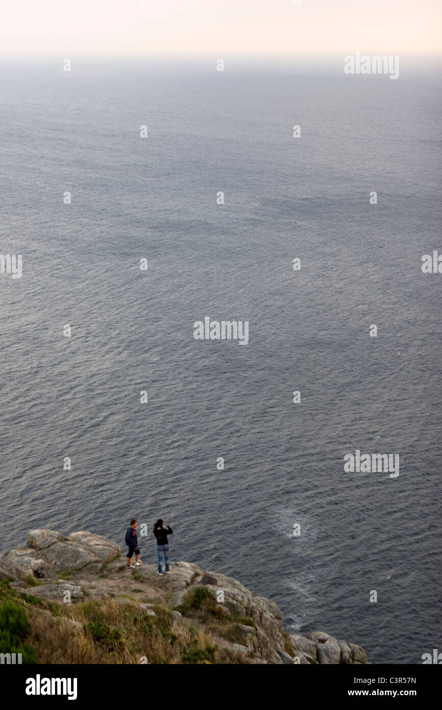 Couple at the edge Finisterre cape. Galicia, Spain Stock Photo