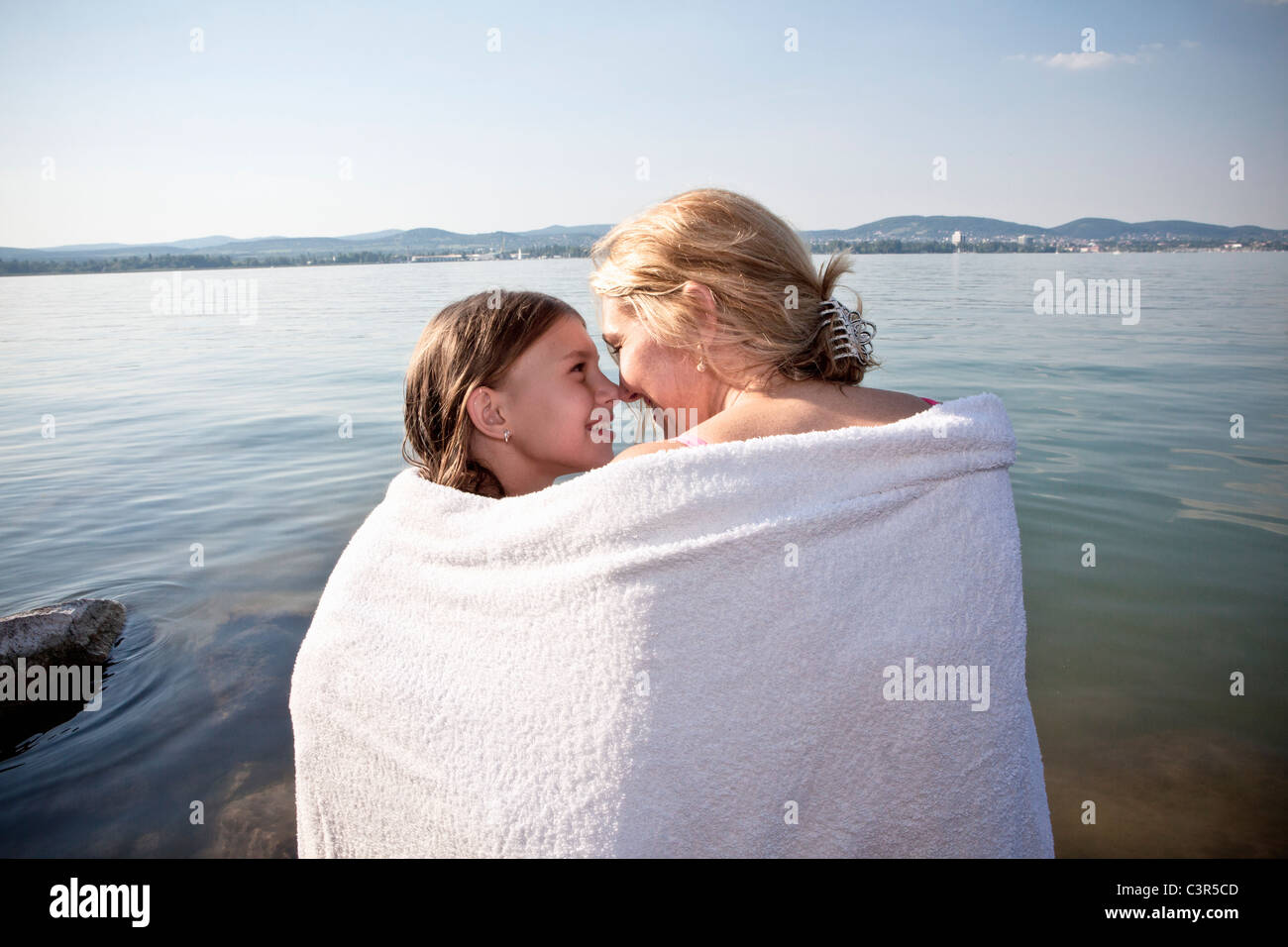 Mother and daughter wrapped in towel Stock Photo