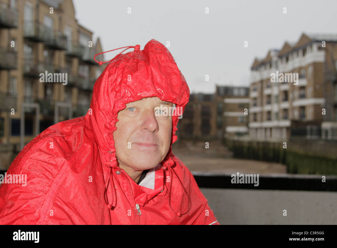 Man in raincoat Stock Photo