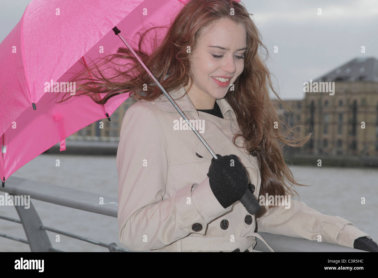 Young woman with pink umbrella Stock Photo