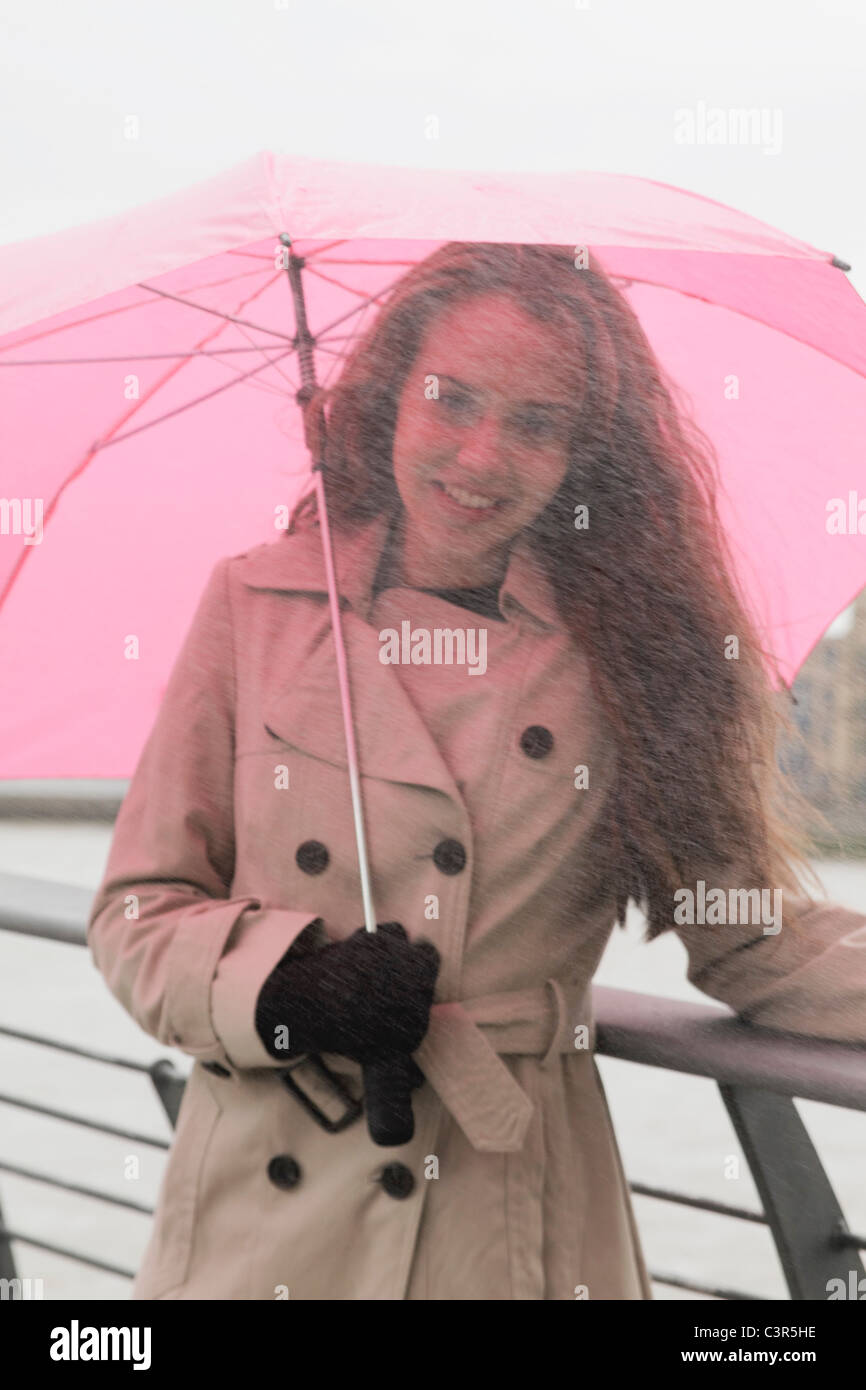 Young woman with umbrella in rain Stock Photo