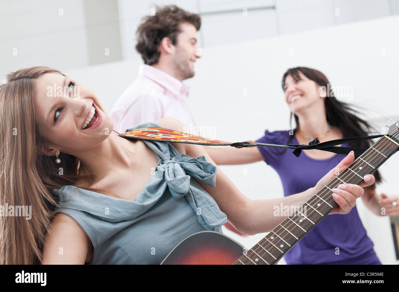 Singing and playing guitar Stock Photo