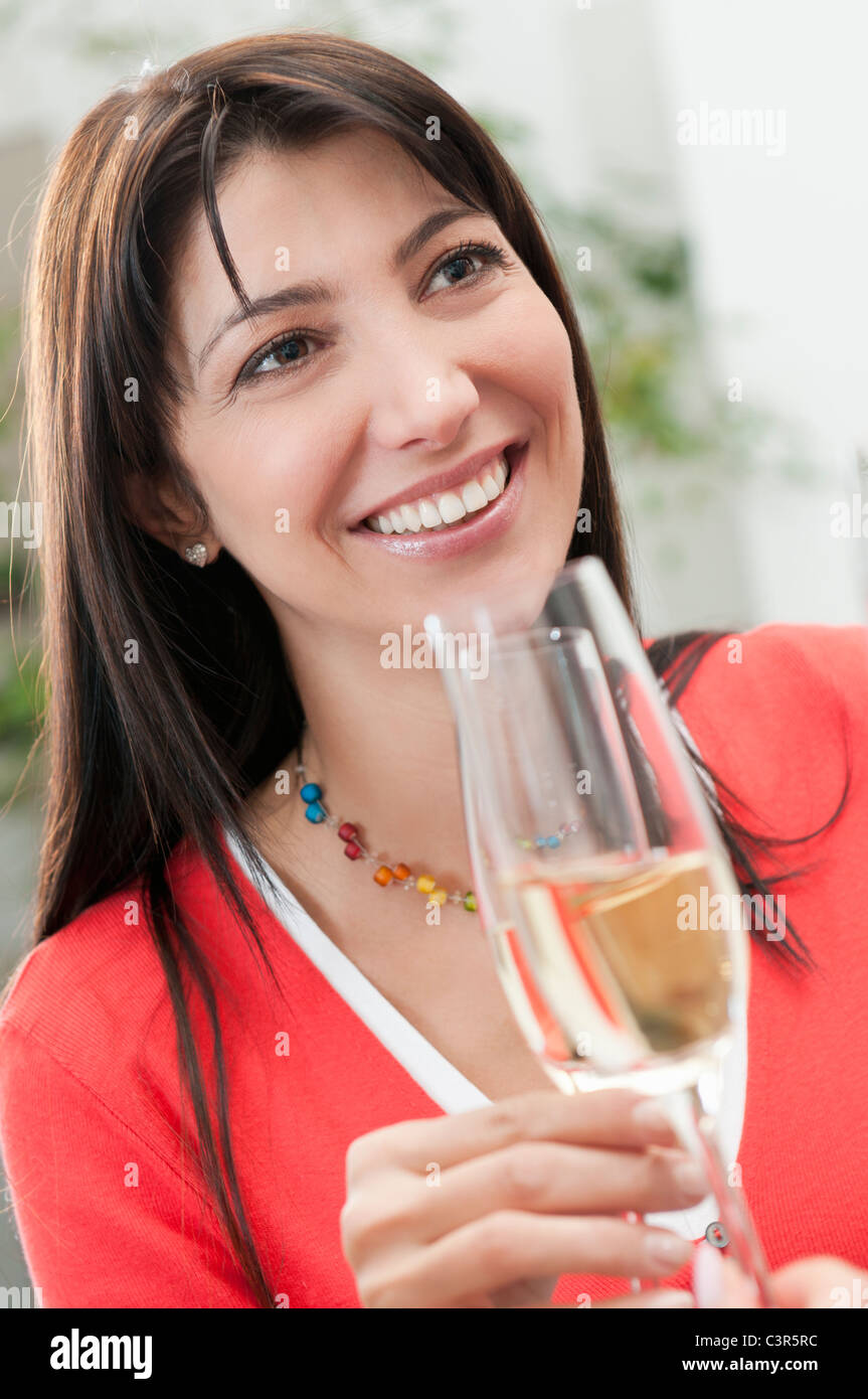 Smiling woman drinking glass of wine Stock Photo