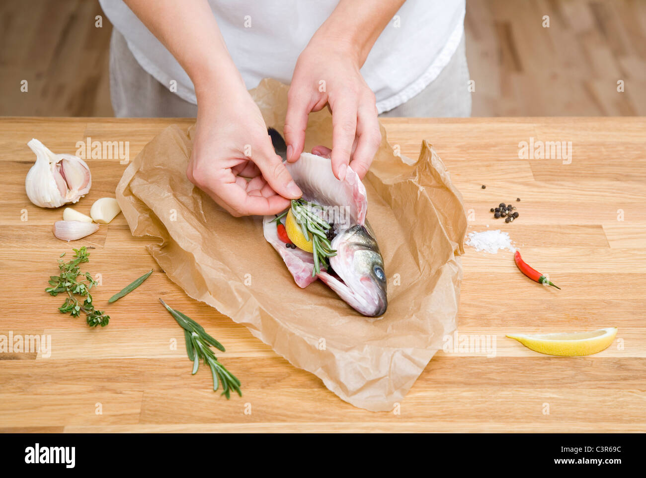 Preparing fish with herbs, spices, lemon Stock Photo Alamy